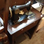 A MERTON TRESTLE SEWING MACHINE