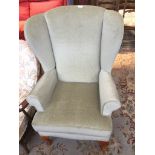 A GREEN WING BACK CHAIR