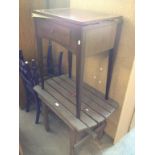 A SINGER SEWING MACHINE IN CABINET AND A WOODEN SLAT TABLE