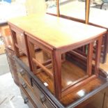 A NEST OF TEAK TABLES