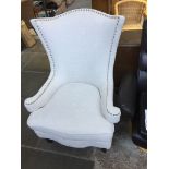 A GREY UPHOLSTERED CONTEMPORARY WING BACK ARMCHAIR