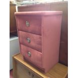 A PINK UPHOLSTERED FRONT BEDSIDE CABINET