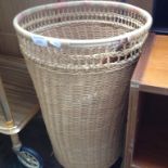 A WICKER WASTE PAPER BIN AND LEATHER FOLDER