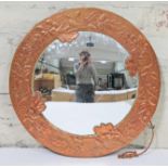 An Arts & Crafts copper framed mirror embossed with acorns, diam. 42cm.