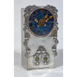 A Tudric pewter clock designed by Archibald Knox for Liberty & Co, having enamel dial, gilt brass