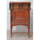 An Arts & Crafts style oak bureau cabinet by Shapland & Petter, Barnstable, with copper strap