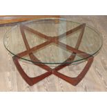A teak and glass top coffee table, circa 1970, diam. 85cm & height 38cm.