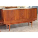 A Danish teak 1960s sideboard with slide doors revealing fitted central cupboard and shelves