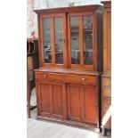 A Victorian mahogany cabinet bookcase with sliding doors, width 133cm, depth 44cm & height 210cm.