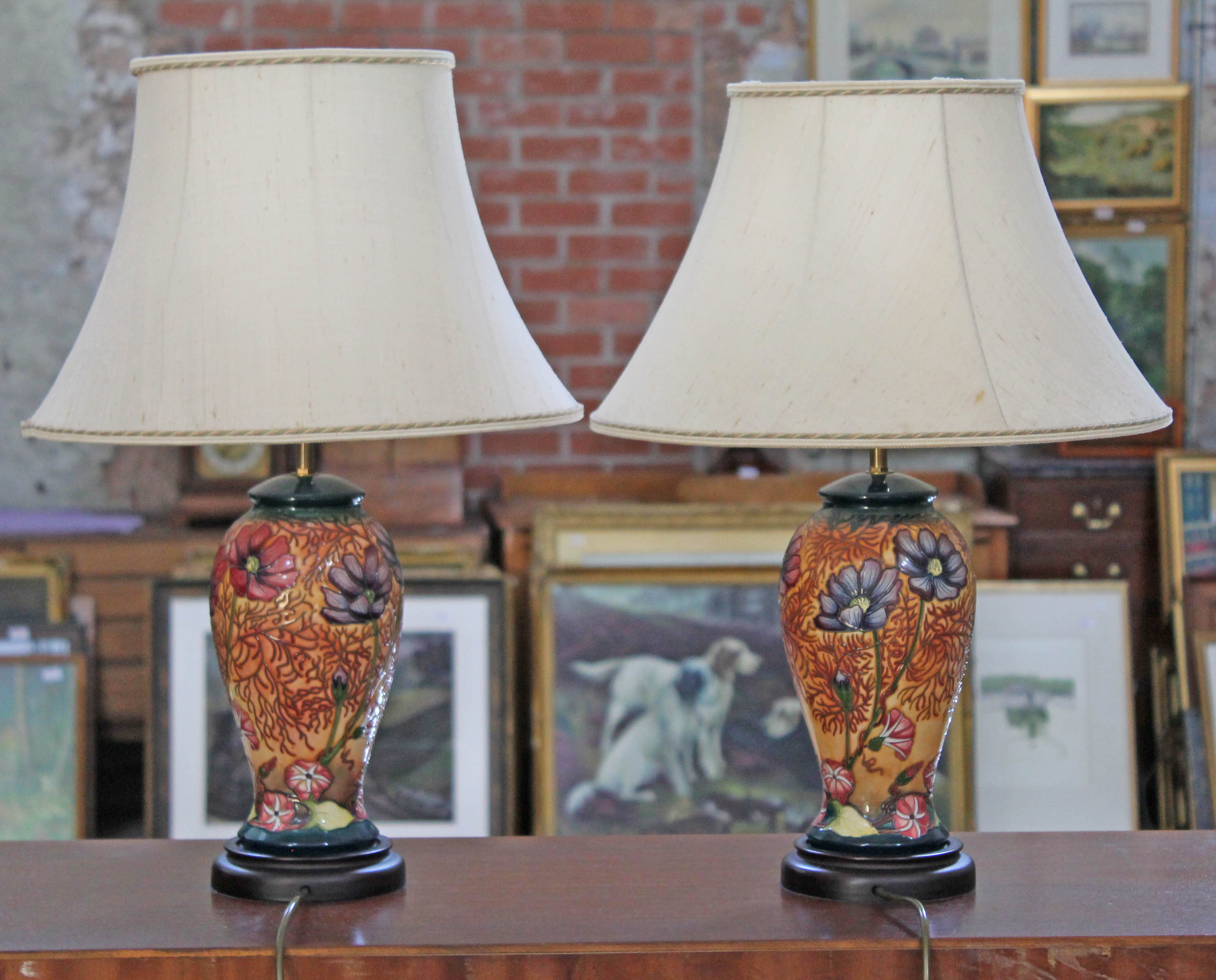 A pair of modern Moorcroft Cosmos pattern pottery table lamps with tube lined floral decoration,