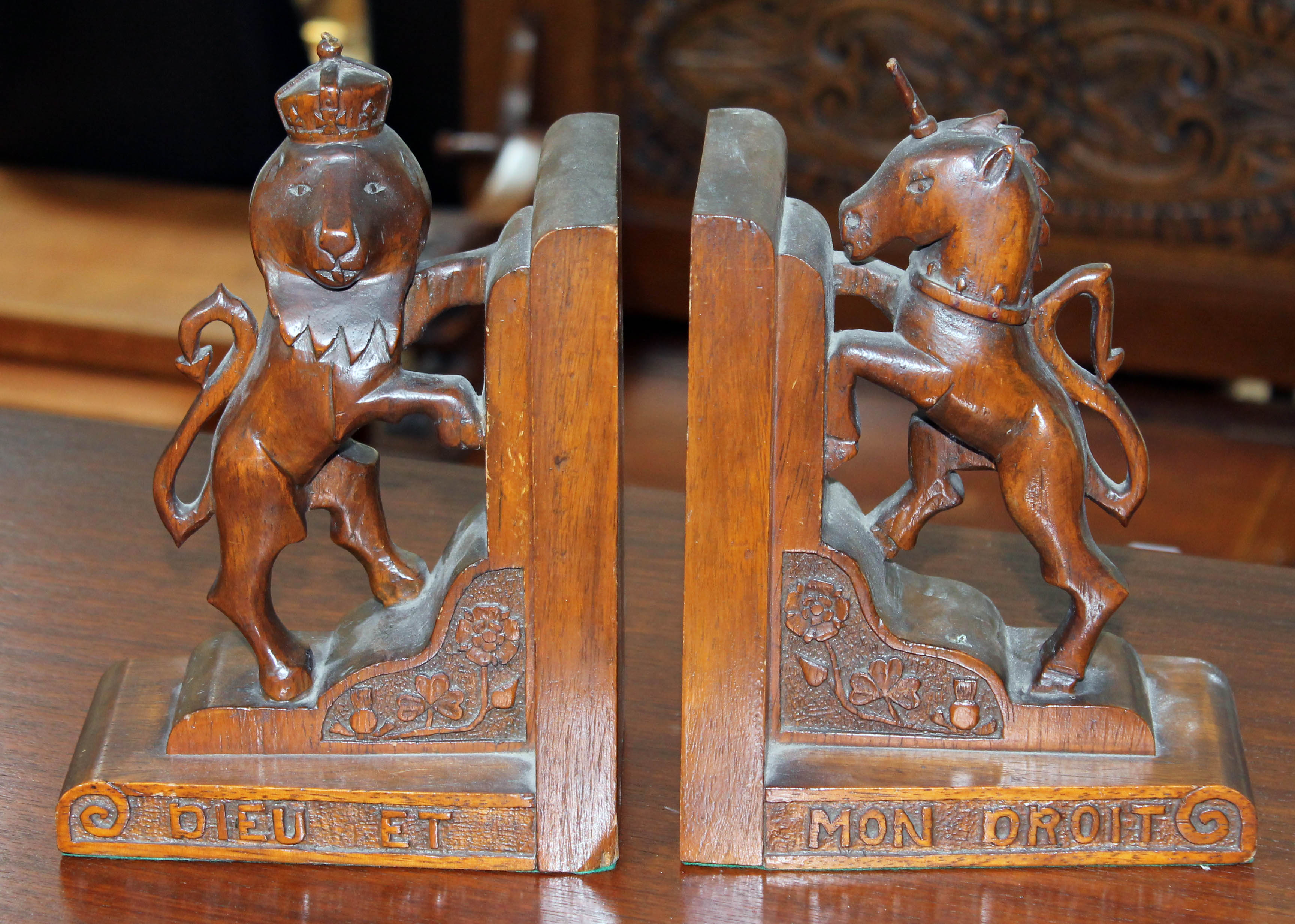 A pair of carved oak Heraldic style bookends.