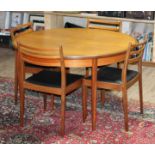 A G-Plan teak extending table and 4 chairs, table diam. 122cm & height 73cm.