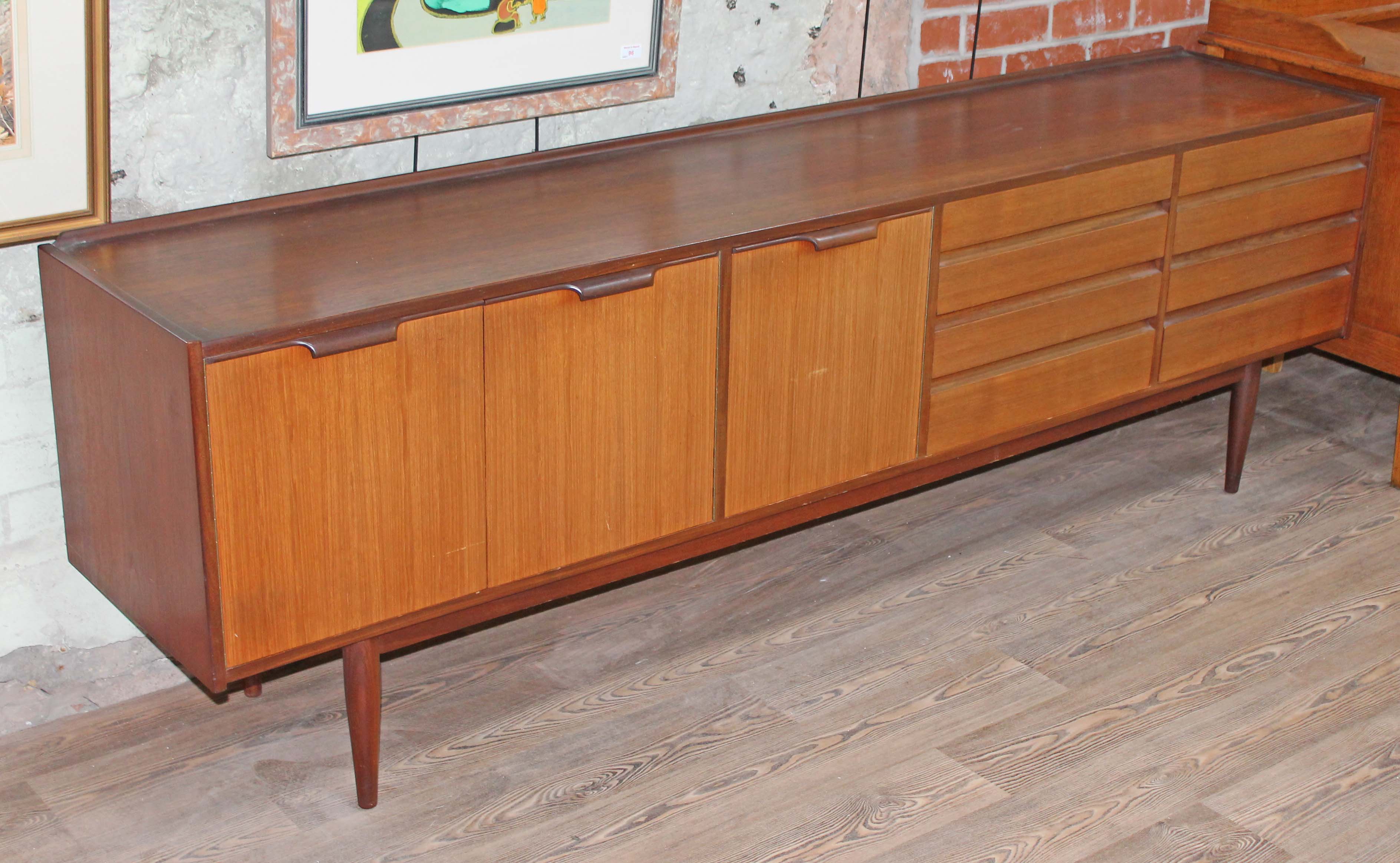 A 1970s retro teak sideboard with oak lined drawers, length 229cm, depth 46cm & height 72.5cm.