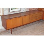 A 1970s retro teak sideboard with oak lined drawers, length 229cm, depth 46cm & height 72.5cm.