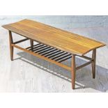 A teak 'surfboard' coffee table with visible dowel joints and lower spindle rail, length 121cm.