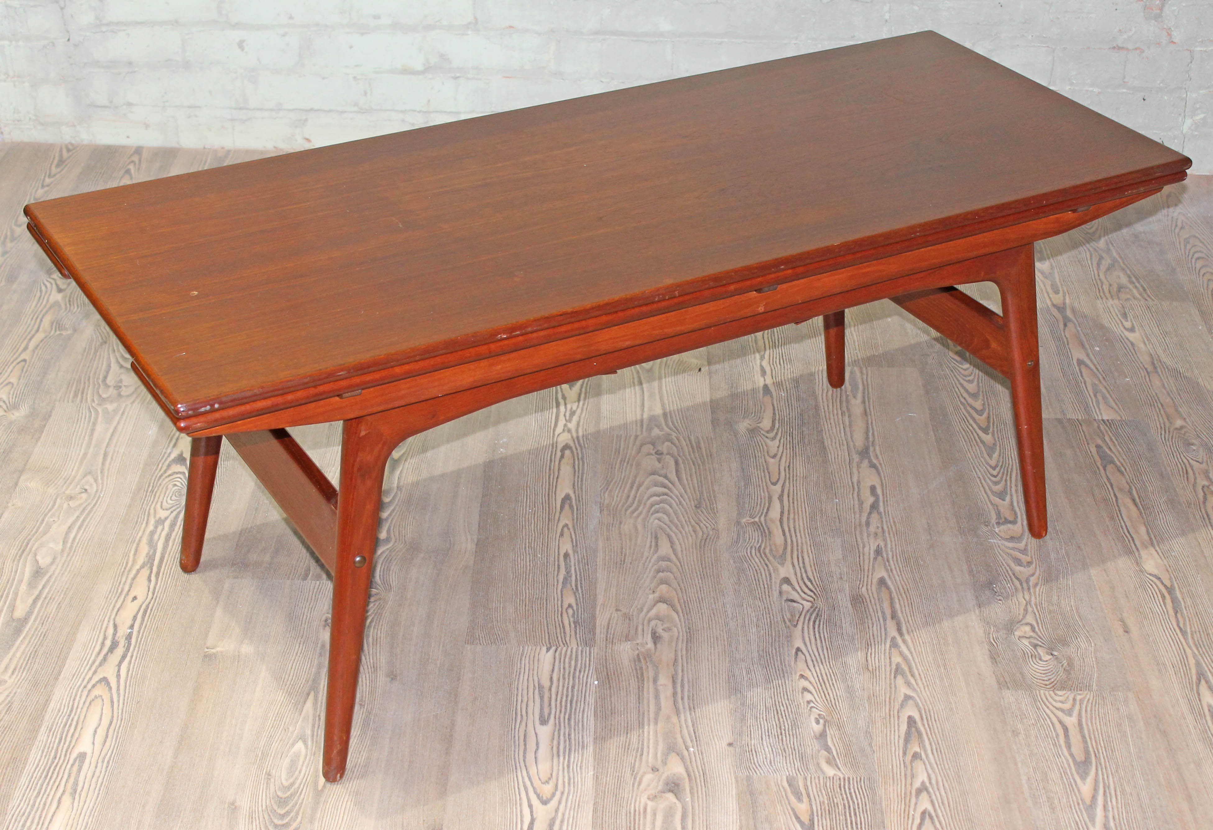 A Danish teak 1960s metamorphic coffee/dining table, min. width 55cm, length 134.5cm & min. height