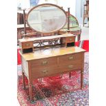 An Edwardian crossbanded mahogany dressing table with oval mirror and gilt brass handles stamped '