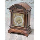 A domed top mantel clock with brass and steel dial, height 45cm.