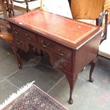 A REPRODUCTION MAHOGANY KNEE HOLE DESK WITH TOOLED LEATHER TOP. W98CM D51CM H77CM