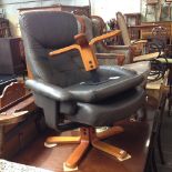 A GREY EASY CHAIR WITH STOOL.