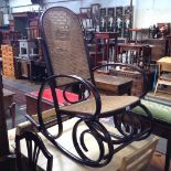 A BENTWOOD BERGERE ROCKING CHAIR.