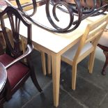 A MODERN LIGHTWOOD TABLE AND TWO CHAIRS.