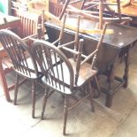 AN OAK DROP LEAF TABLE AND FOUR CHAIRS.