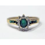 A 9ct gold diamond and emerald ring, gross wt. 2.3g, size O.