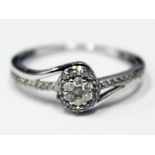 A modern hallmarked 9ct white gold diamond encrusted ring, gross wt. 2.4g, size R.