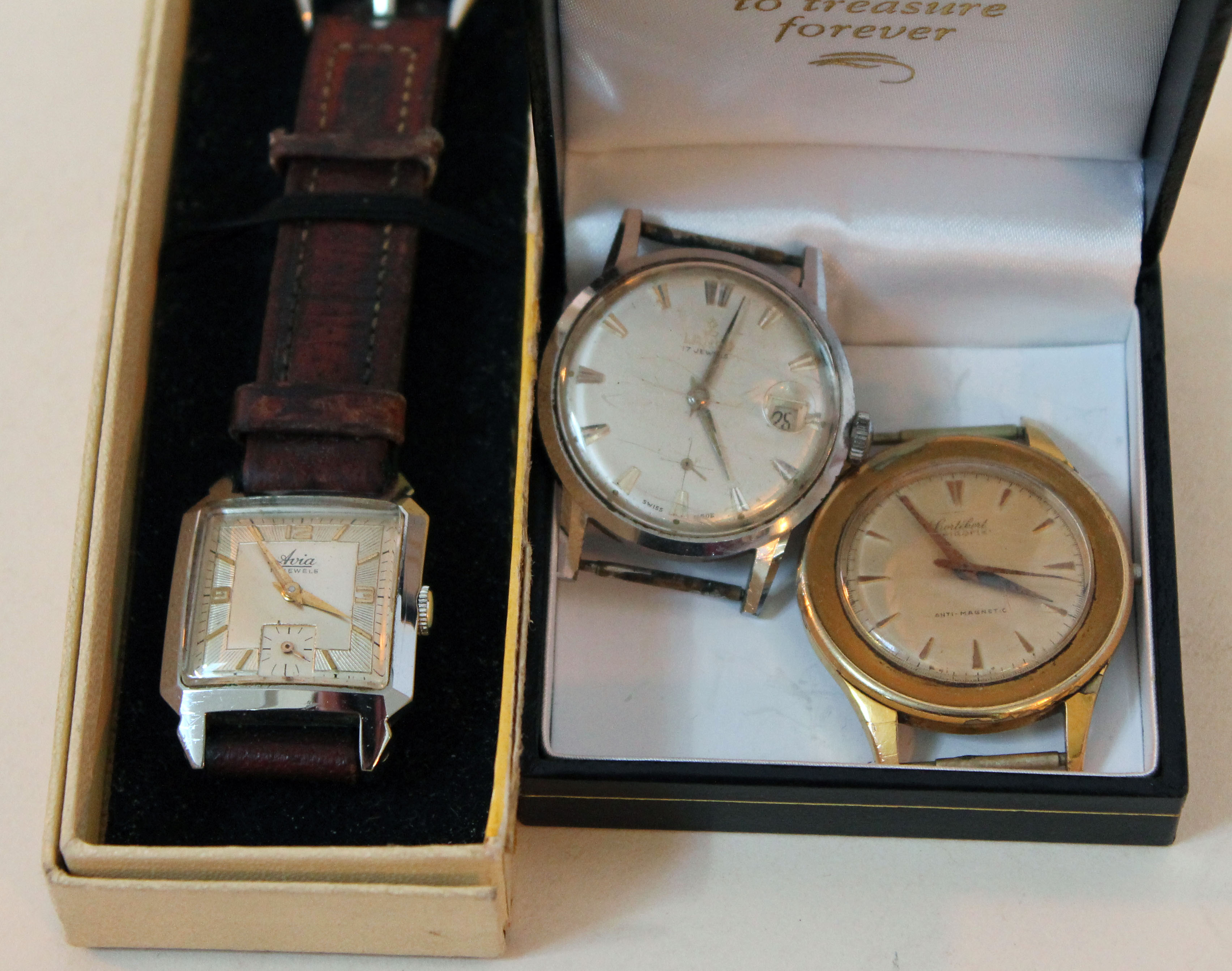 A group of three vintage wristwatches.