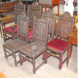 A group of six carved oak chairs.