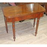 A 19th Century mahogany fold over tea table with turned legs, width 91cm, depth 46cm & height 77cm.