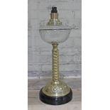 An Arts & Crafts style twist brass lamp base with facetted glass reservoir and pot base, height