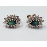 A pair of 9ct gold diamond and emerald earrings, gross wt. 0.8g.