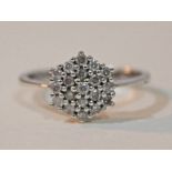 A hallmarked 9ct white gold diamond cluster ring, gross wt. 2.7g, size N.