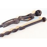 Two African carved hardwood walking canes, one carved as a figure, the other with entwinned snake,