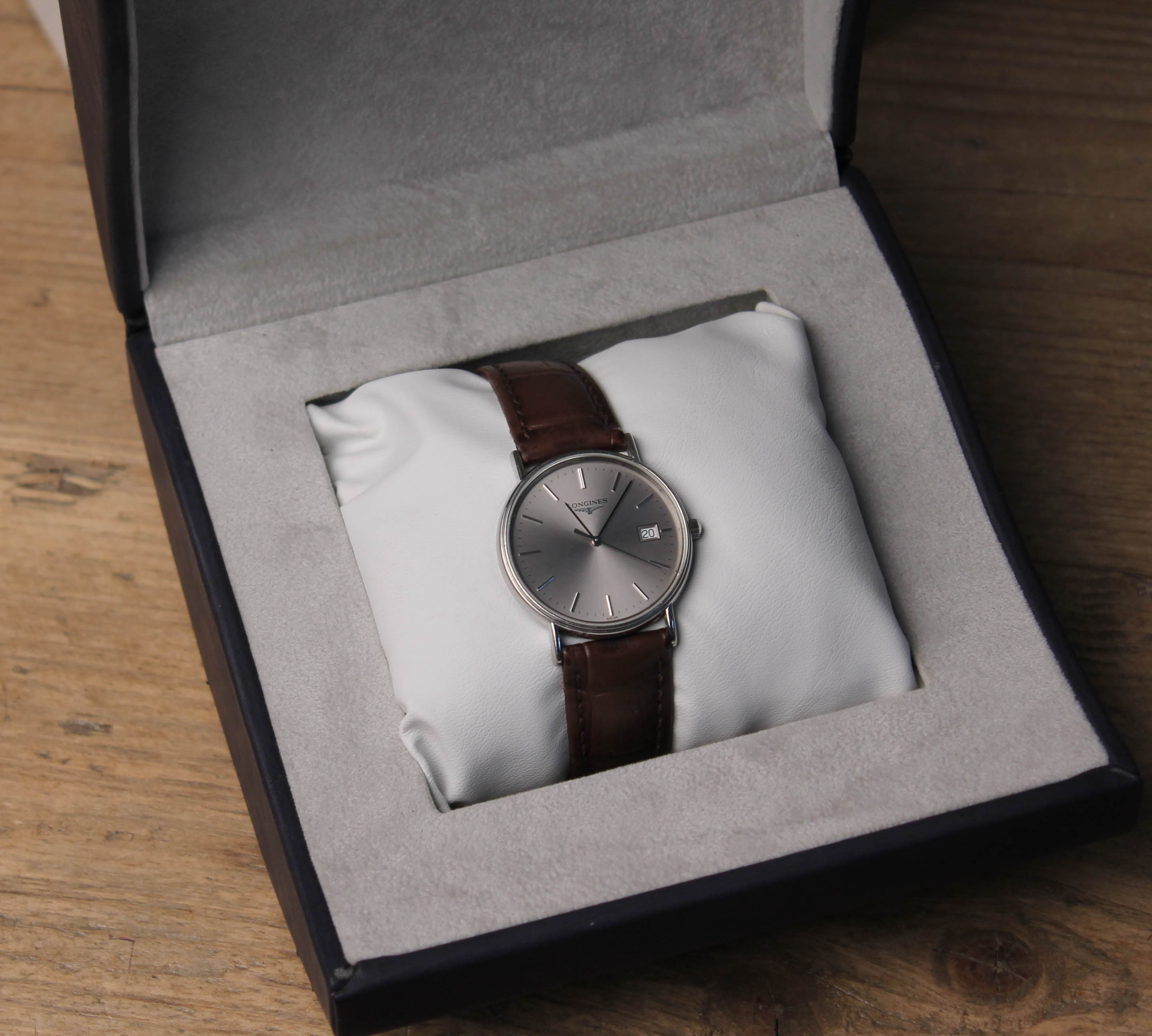 A Longines wristwatch with leather strap and box.