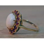 A hallmarked 9ct gold ruby and opal ring, gross wt. 4.8g, size R.