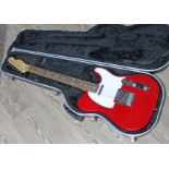 A Fender USA Telecaster in candy apple red, serial number N5102638, with hard case.