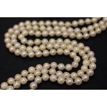 An Edwardian three strand cultured pearl necklace having gold clasp marked '9ct' set with half cut