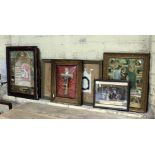 A group of six religious pictures including a crucifix behind a domed glazed frame.