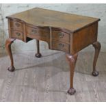 A George II style figured and burr walnut five drawer knee hole desk, having cabriole legs with