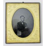 A photographic portrait depicting a gentleman, oval gilt mount and leather bound glazed frame 14.5cm