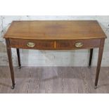 An Edwardian Sheraton style bow front mahogany two drawer side table, with satinwood stringing, gilt