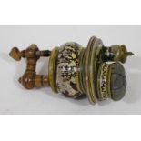 A 19th Century Tunbridge sewing clamp with pin cushion and tape measure, length 16cm.