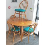 An Ercol light elm and beech drop leaf table and four chairs.