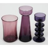 Three pieces of purple art glass comprising a Wedgwood Sherringham candlestick with three discs
