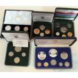 A group of five coin proof sets.