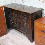 An oak sideboard circa 1900 with Heraldic style carved panels, length 149cm, depth 53cm & height
