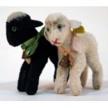 Two Steiff Lamby soft toys.